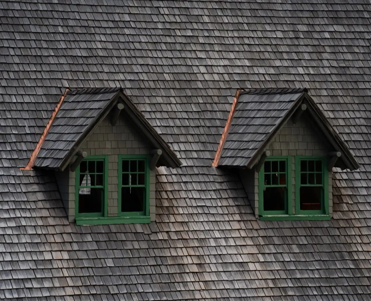 Dormers on a shingle roof in Edinburg, TX, where step flashing and kickout flashing carry water past the walls